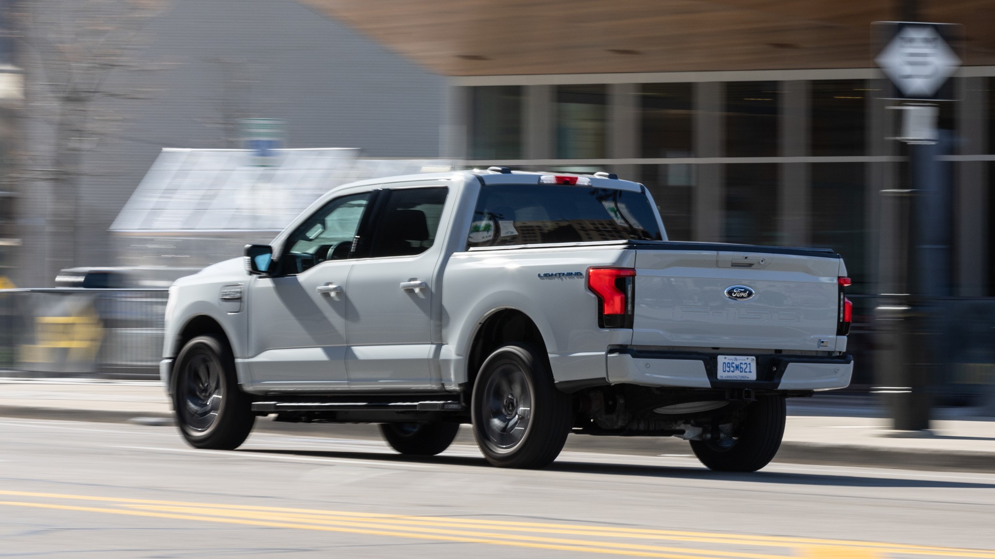 066 2023 Ford F 150 Lightning XLT rear three quarters in action