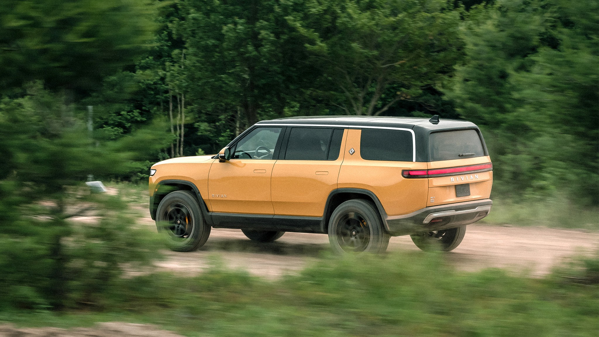 2023 Rivian R1S motion rear three quarter view 2