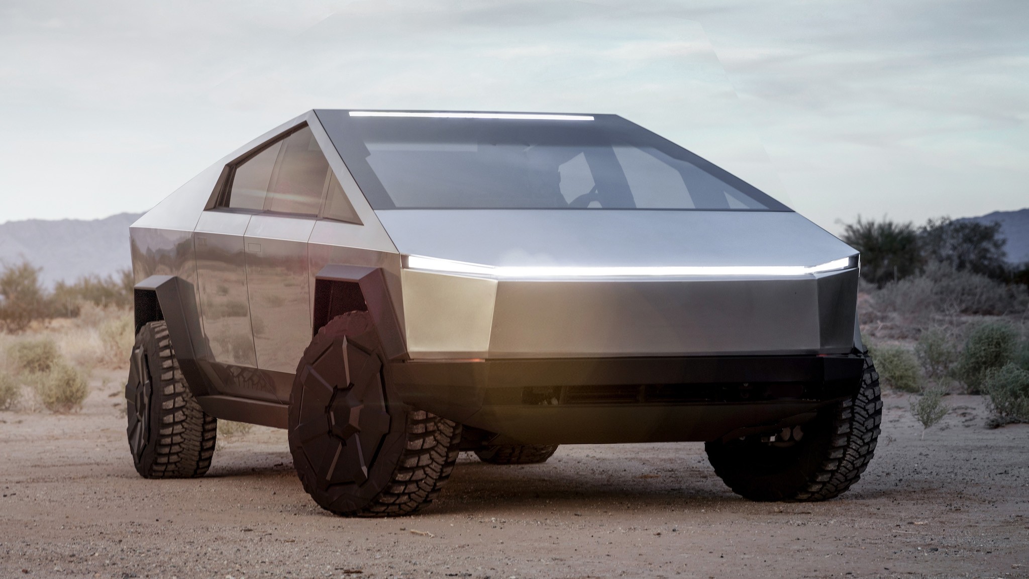 Tesla Cybertruck Electric Pickup Truck Front 3 4 View with Off Road Lights and Headlights Illuminated