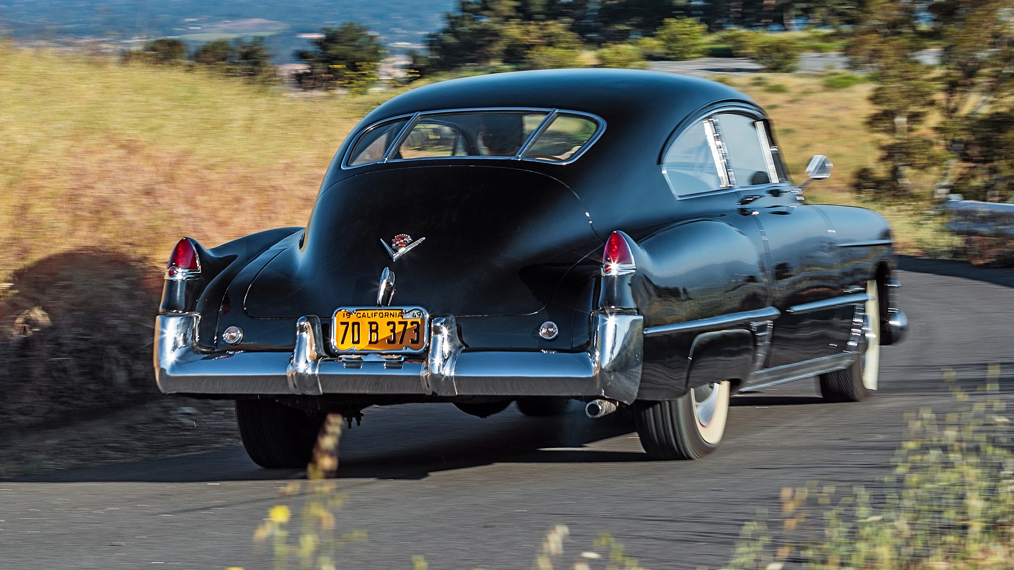 1949 Cadillac Series 62 Sedanette rear three quarter in motion