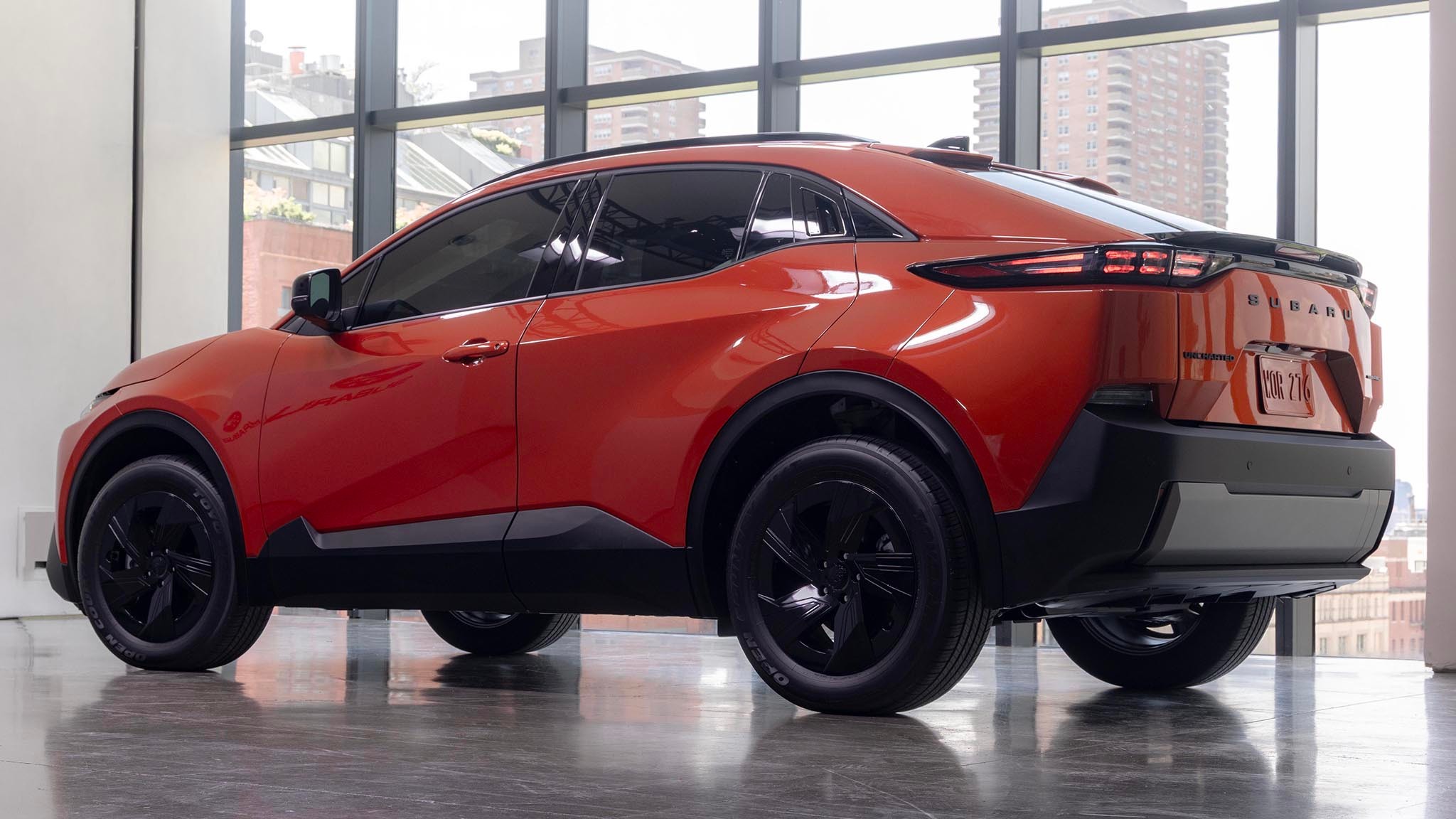 2025 Subaru Uncharted in orange low rear three quarters