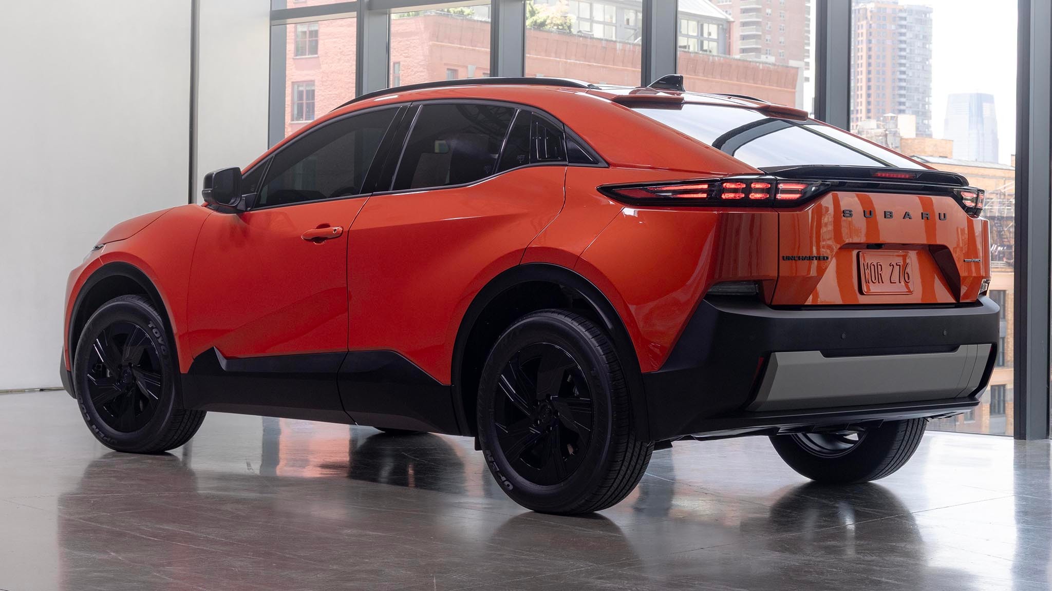 2025 Subaru Uncharted in orange rear three quarters