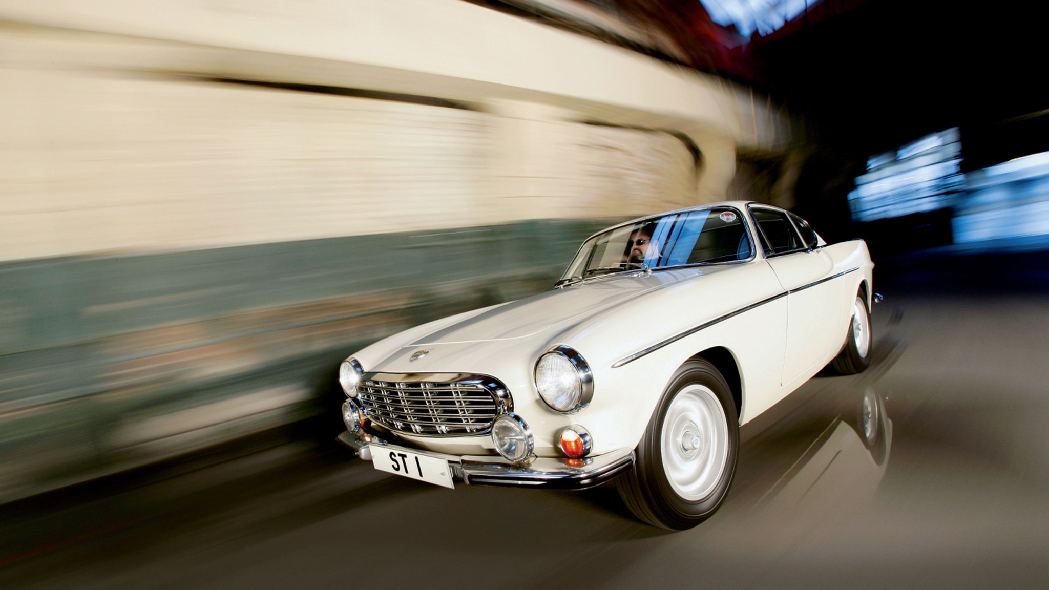 008 roger moore volvo p1800 saint front three quarter driving refurb