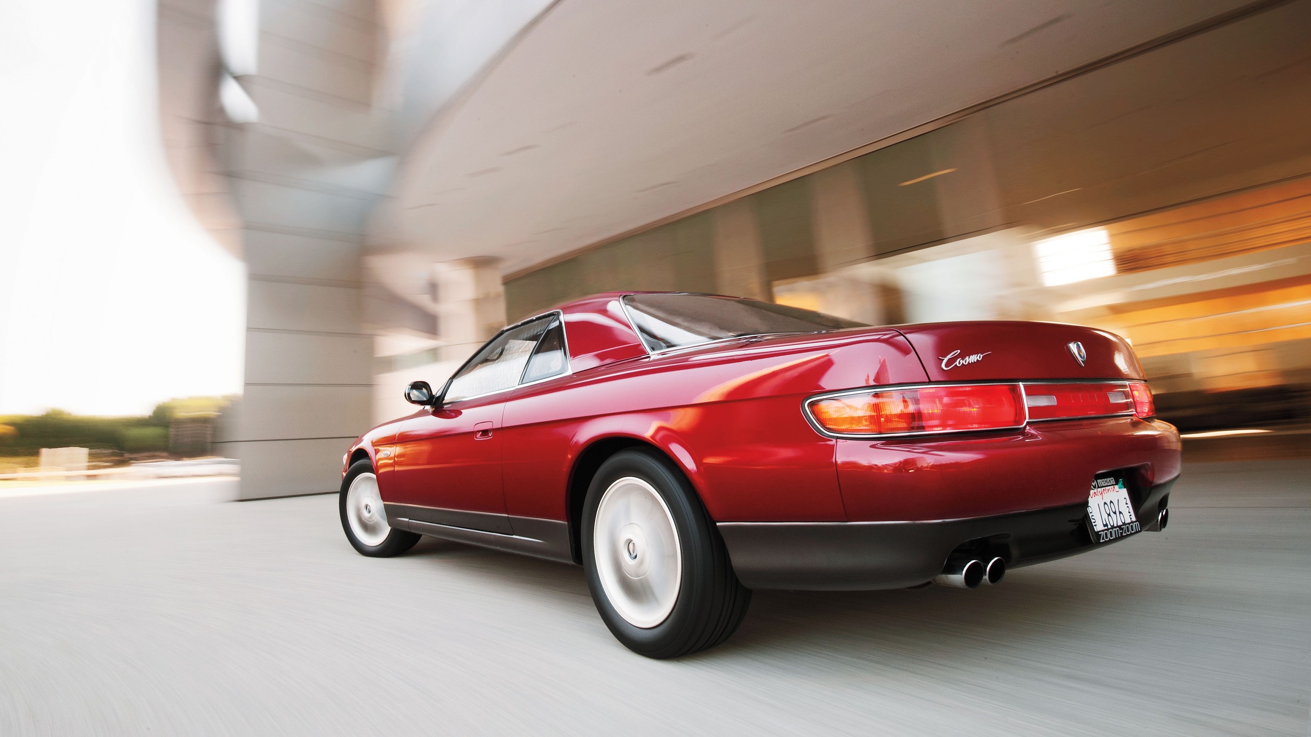 018 1993 mazda eunos cosmo rare 3 rotor red rear three quarter driving luxury coupe