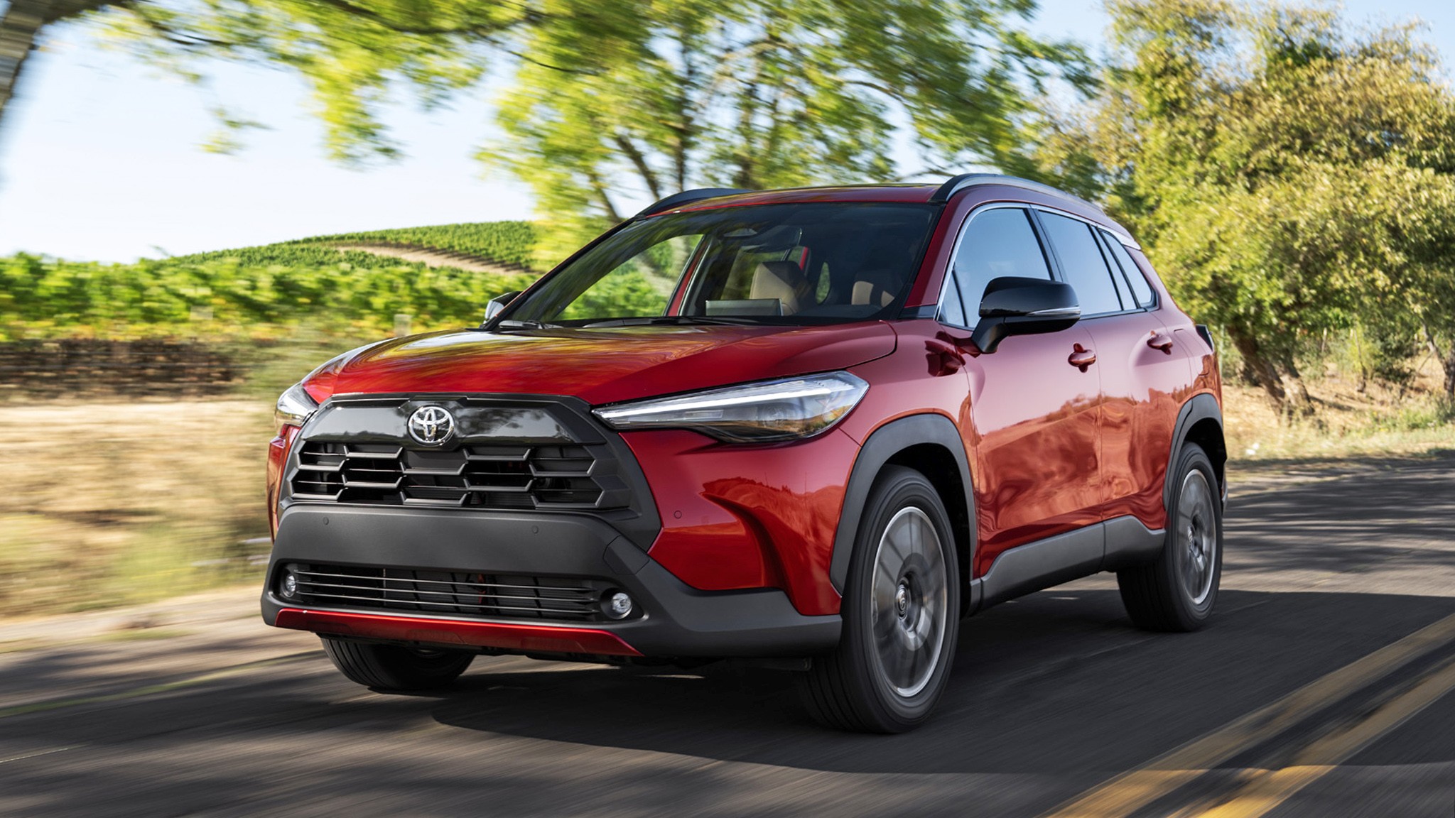 2026 Toyota Corolla Cross XLE AWD redfront three quarter action 200
