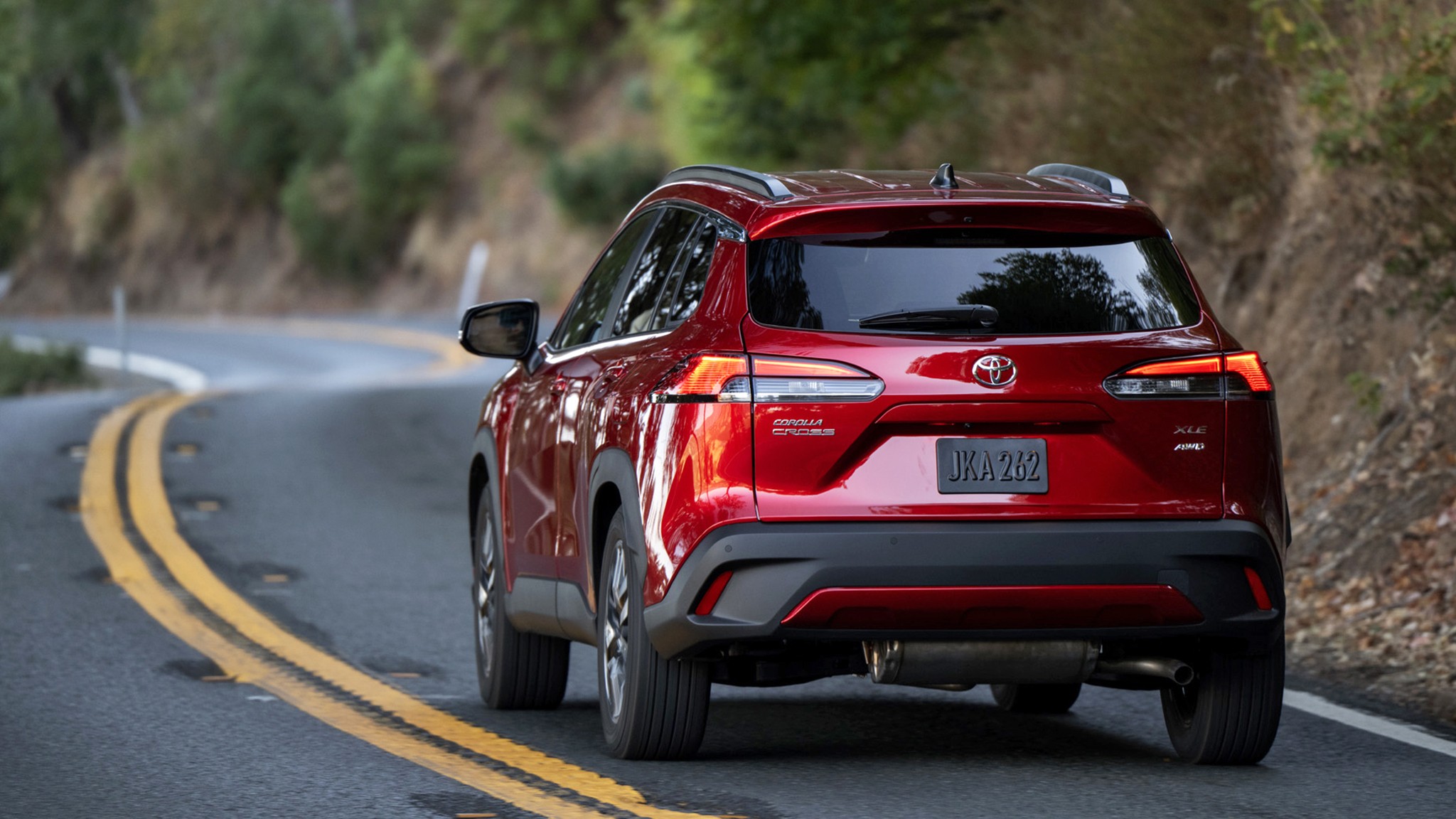 2026 Toyota Corolla Cross XLE AWD red rear action 305