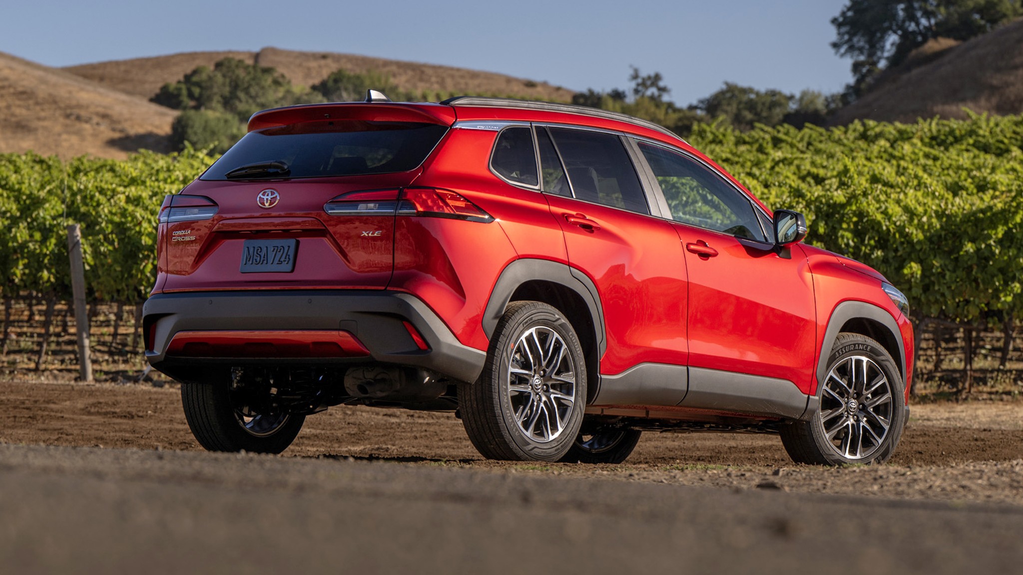 2026 Toyota Corolla Cross XLE FWD red rear three quarter 004